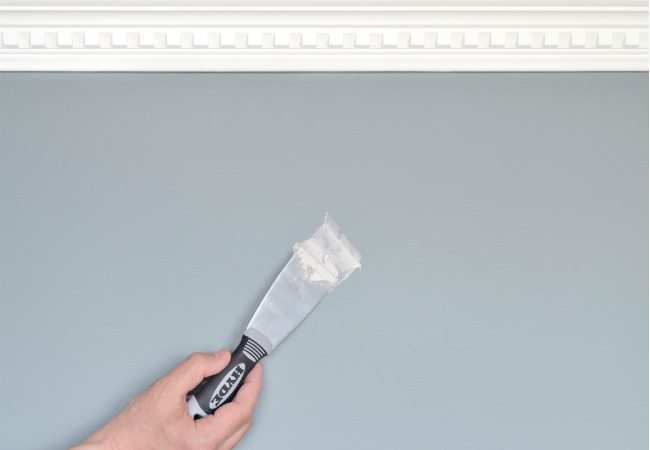 2Inch Putty Knife Filling a Nail Hole - Patching Holes in Your Rental Home Walls