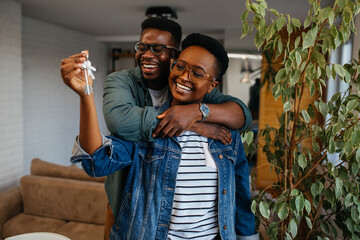 a couple holding keys as they are celebrating their new rental home with California Leasing